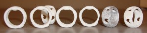 Rings in a line.  Notice the two right most rings I've in the same orientation for comparison - a heart shape hole is missing on the silver one.
